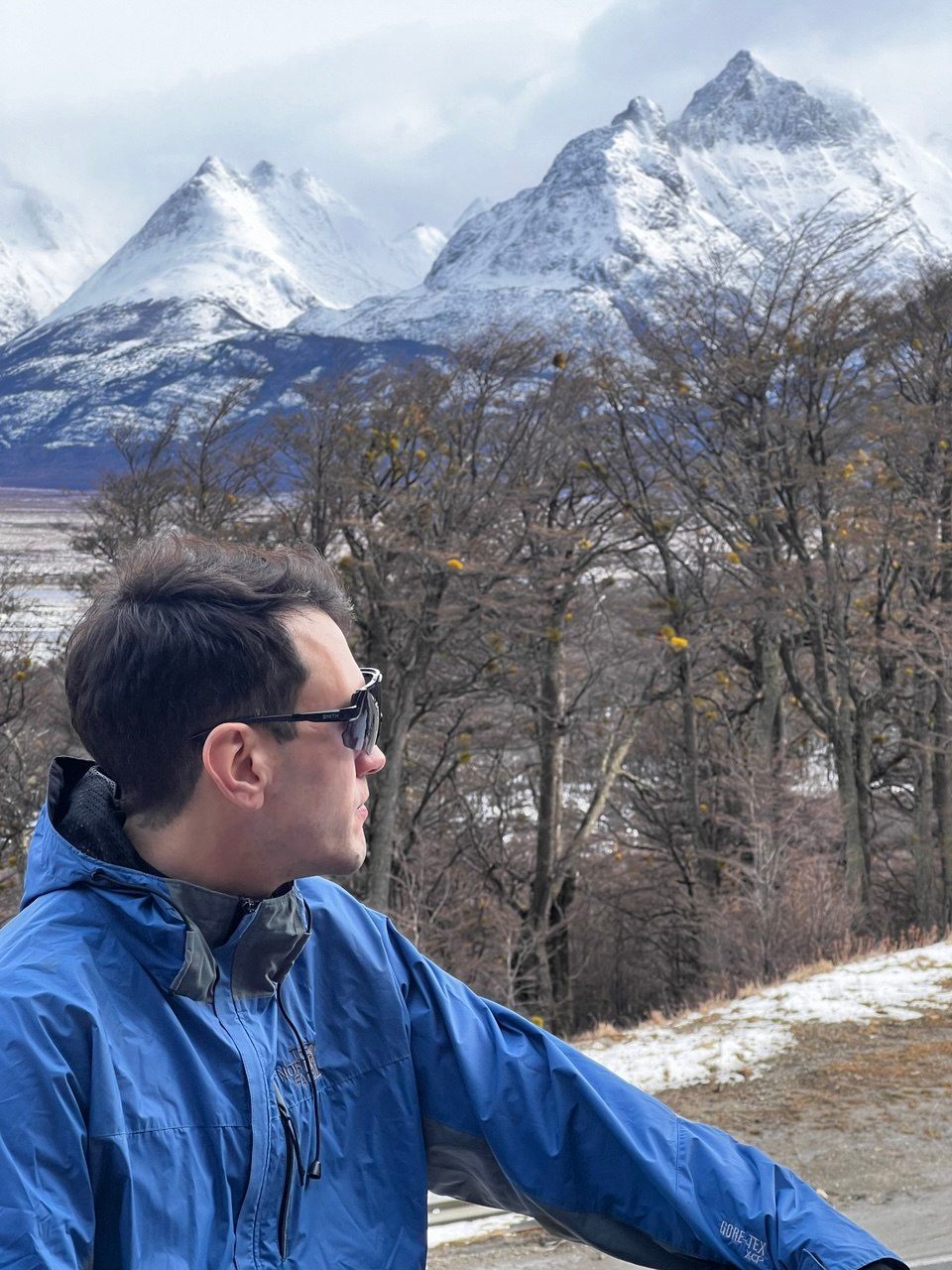 Traveler overlooking the snowy peaks of Ushuaia